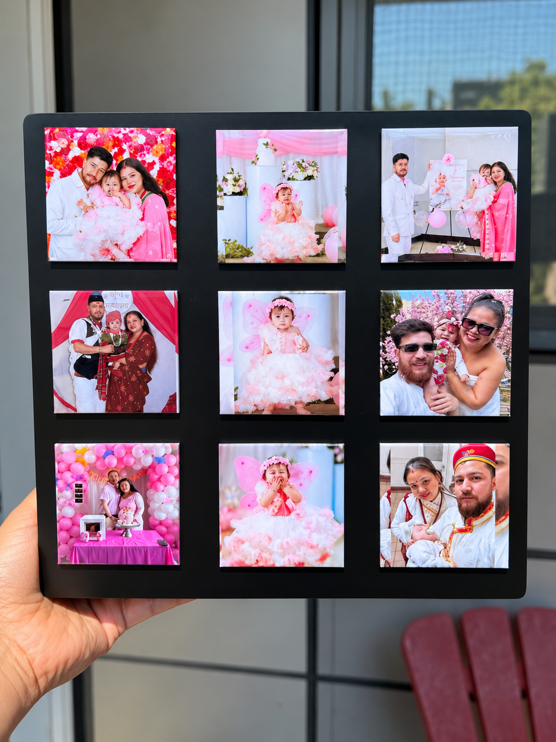 A display board held in a hand showing nine finished photo magnets